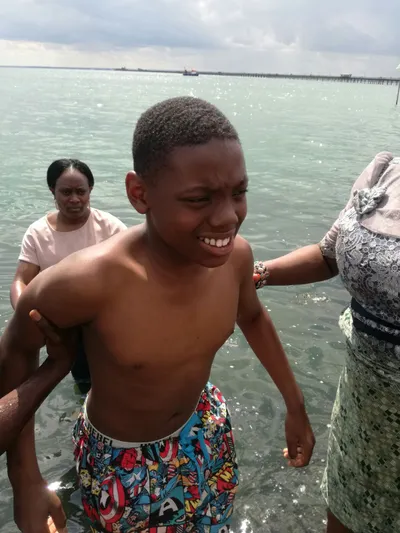 Baptism by immersion of a boy by a woman