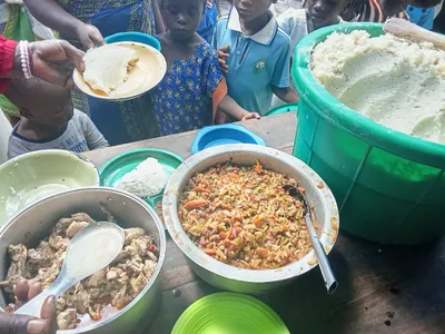 Pots of food being served to children