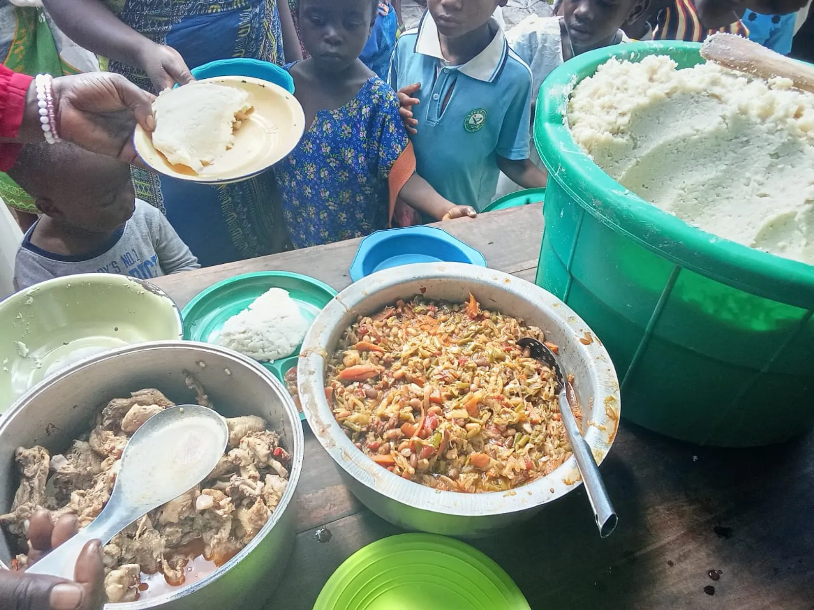 Pots of food being served to children