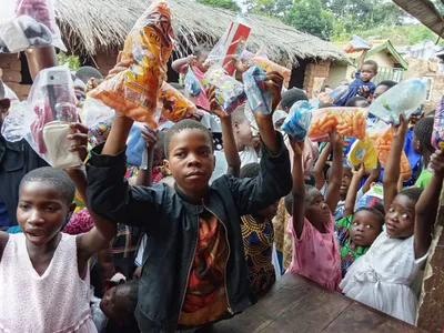 Children with food items raised up